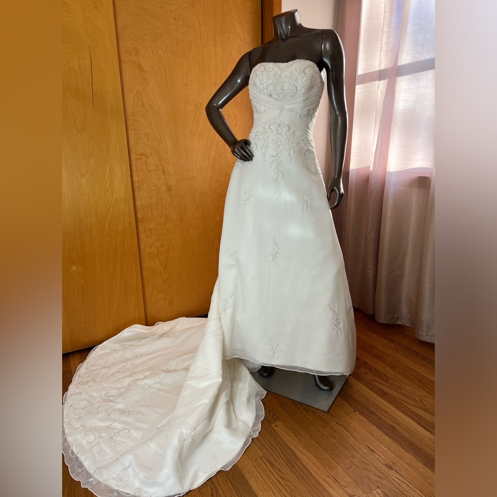 Ivory empire waist A - line wedding gown with corset lace back.
